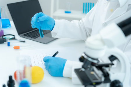 Scientist checks chemical food residues in laboratory. Control experts inspect quality of fruits,...