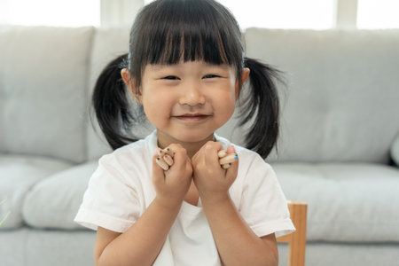 Little girl show paint, Happy children playing learn paint on paper. Activity, development, IQ, EQ, meditation, brain, muscles, essential skills, family having fun spending timeの写真素材