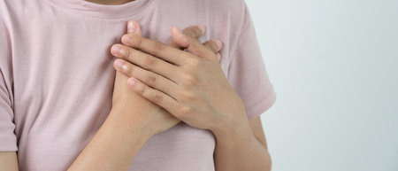 hand hold chest with heart attack symptoms, asian woman have chest pain caused by heart disease,...
