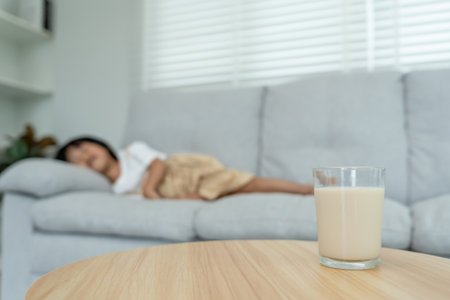 Milk allergens, children felling stomachache and diarrhea , runny stuffy sore nose suffer from intolerance allergy trigger symptoms. abdominal pain nut proteinの写真素材