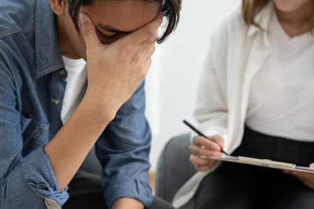 man with mental health problems is consulting. psychiatrist is recording the patient's condition for treatment. encouragement, love and family problem, bipolar , depression patientの写真素材