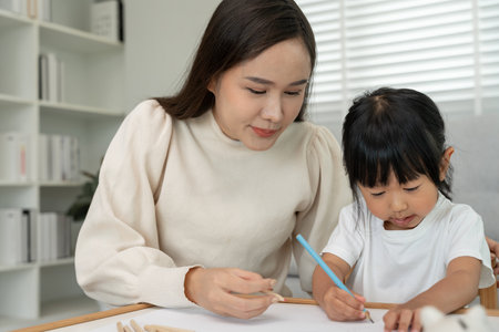 Happy mother play and learn drawing for little girl. Funny family is happy and excited in the house. Mother and daughter having fun spending time together. Holiday, Activityの写真素材