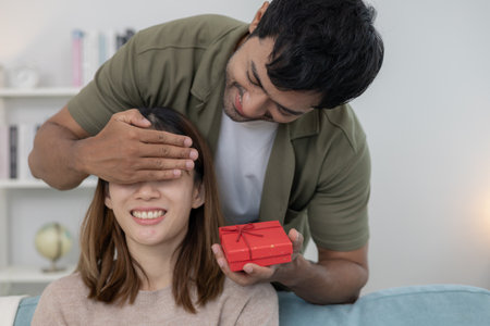 Happy husband seek and hide gift box for surprise wife. cute girl excited  gift box. birthday, Celebration, xmas, New year Festival, thank, Celebrate, Valentineの写真素材