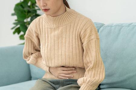 stomach ache. Asian women have abdominal pain, indigestion, gastritis, menstrual cramps, flatulence, diarrhea, distention, colon cancer, belly inflammation problem,の写真素材