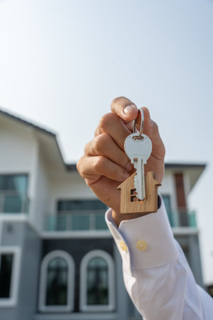 lease, rental and selling home. Real estate agent manager smile holding key for new owner. rent house, Sales, loan credit financial, insurance, Seller, dealer, installmentの写真素材