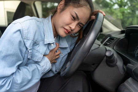hand hold chest with heart attack symptoms, Accident from business woman working hard have chest pain caused by heart disease, leak, dilatation, enlarged coronary heart,の写真素材