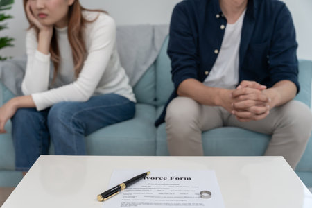 Divorce. Couple remove married ring and sign Divorce form. Couples desperate and disappointed after marriage. wife sad, upset and frustrated after quarrels conflictの写真素材
