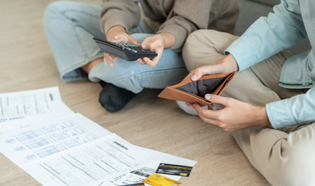 Stressed and headache couple with large bills or invoices no money to pay to expenses and business...