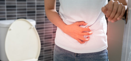 diarrhea in bathroom. Hurt woman touch belly  stomach ache painful. colon inflammation problem, toxic food, abdominal pain, abdomen, constipated in toilet, stomachache, Hygieneの写真素材