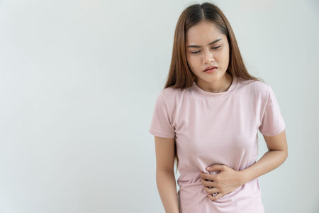 stomach ache. Asian women have abdominal pain, indigestion, gastritis, menstrual cramps, flatulence,...