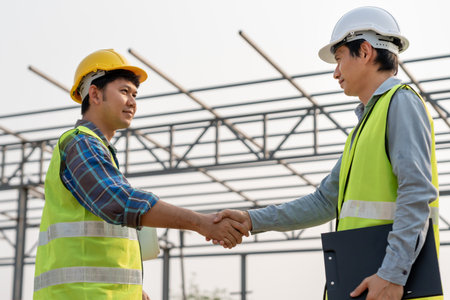 Construction team hands shaking greeting start up plan new project contract in office center at construction site, industry ,architecture, partner, teamwork, agreement, propertyの写真素材