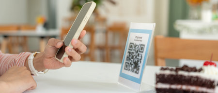 Woman use smartphone to scan QR code for order menu in cafe restaurant with a digital delivery....