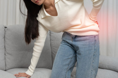 woman holding lower back while and suffer from unbearable pain health and problems, chronic back...