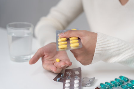 girl holding medicine and take medicine, pain, cure disease, sterilize, take vitamin, sedative, health care, Dietary supplement, medicine for medical treatment, tonic,の写真素材