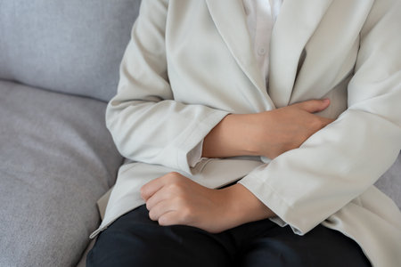 Business woman have stomach ache. Stomach ache due to eating irregularly, menstrual cramps, flatulence, diarrhea, bloating, bloating, abdominal inflammation, food poisoning,の写真素材