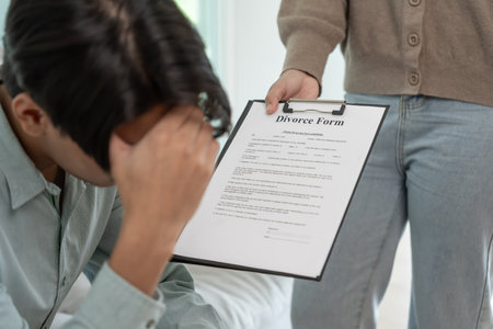 Divorce. Wife pass on Divorce form for husband. Couples desperate and disappointed after marriage. wife sad, upset and frustrated after quarrels conflict. distrust, love problemsの写真素材