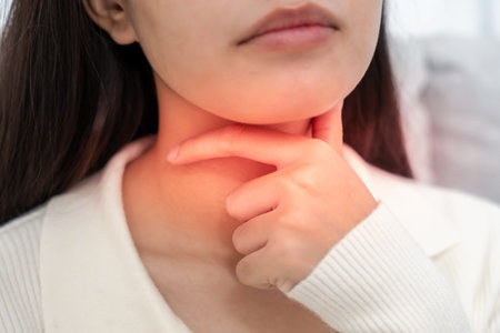 Asian woman put on neck due to a sore throat. female tonsillitis causes a inflammation. treated by...