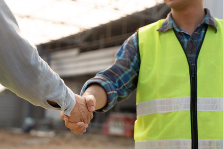 Construction team hands shaking greeting start up plan new project contract in office center at construction site, industry ,architecture, partner, teamwork, agreement,の写真素材