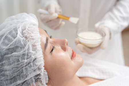 Beautiful woman receive spa and treatment skin of face. face of a healthy woman apply cream. Advertisement for skin cream, anti-wrinkle, baby face, whitening, moisturizer,の写真素材