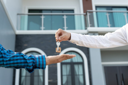 lease, rental and selling home. Real estate agent manager smile holding key for new owner. rent house, Sales, loan credit financial, insurance, Seller, dealer, installment,の写真素材