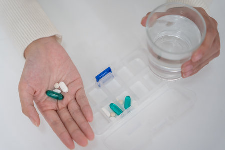 girl holding medicine and take medicine, pain, cure disease, sterilize, take vitamin, sedative, health care, Dietary supplement, medicine for medical treatment, tonic,の写真素材