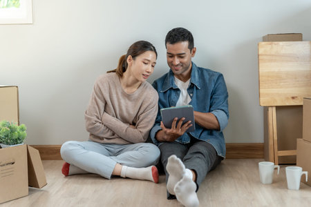 Moving house, relocation. Couple choose design for building new apartment, inside the room was a...