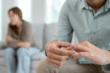 Divorce. Man remove married ring. Couples desperate and disappointed after marriage. Husband wife sad, upset and frustrated after quarrels conflict. distrust, love problems,の写真素材