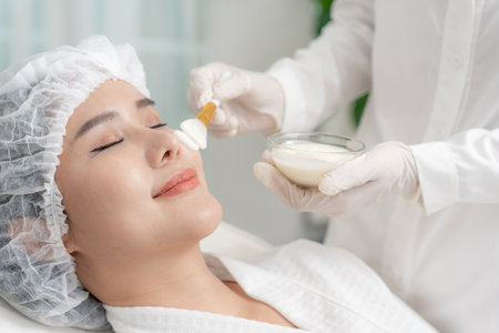 Beautiful woman receive spa and treatment skin of face. face of a healthy woman apply cream. Advertisement for skin cream, anti-wrinkle, baby face, whitening, moisturizer,の写真素材