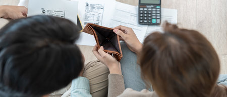 Stressed and headache asian couple with large bills or invoices no money to pay to expenses and credit card debt. shortage, Financial problems, mortgage, loan, bankruptcy,の写真素材