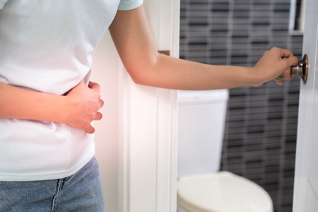 diarrhea in bathroom. Hurt woman touch belly  stomach ache painful. colon inflammation problem, toxic food, abdominal pain, abdomen, constipated in toilet, stomachache, Hygieneの写真素材
