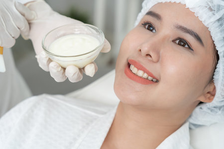 Beautiful woman receive spa and treatment skin of face. face of a healthy woman apply cream. Advertisement for skin cream, anti-wrinkle, baby face, whitening, moisturizer,の写真素材