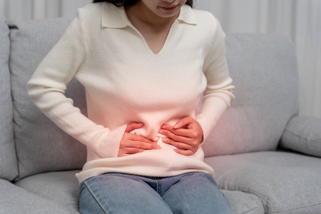 stomach ache. Asian women have abdominal pain, indigestion, gastritis, menstrual cramps, flatulence, diarrhea, distention, colon cancer, belly inflammation problemの写真素材