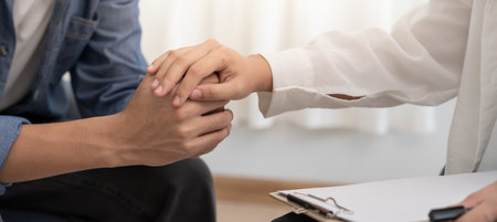 psychiatrist hold hand support each while discussing family issues. doctor encourages and empathy man suffers depression. psychological, save divorce, Hand in hand together,の写真素材