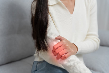 woman holding on elbow and while and suffer from unbearable pain health and problems, chronic shoulder pain, shoulder ache in office syndrome, scoliosis, herniated discの写真素材