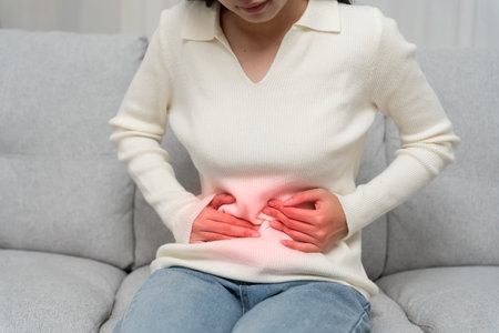 stomach ache. Asian women have abdominal pain, indigestion, gastritis, menstrual cramps, flatulence, diarrhea, distention, colon cancer, belly inflammation problem,の写真素材