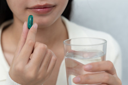 girl holding medicine and take medicine, pain, cure disease, sterilize, take vitamin, sedative, health care, Dietary supplement, medicine for medical treatment, tonicの写真素材