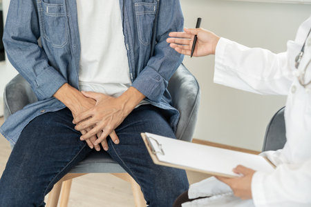 Man hold hand in front of private parts feeling discomfort and consult doctor. Venereal, testicular cancer. bladder problems, erectile dysfunction, premature ejaculationの写真素材