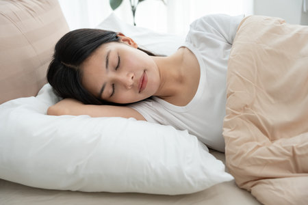 Simple lifestyle, Asian woman sleep well from good sleep on weekend morning, takes some rest, enjoy...