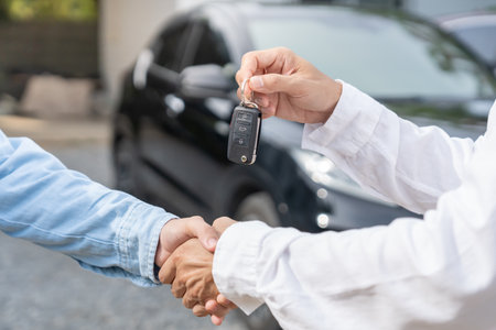 lease, rental car, sell, buy. Dealership manager send car keys to the new owner.  Sales, loan credit financial, rent vehicle, insurance,  renting, Seller, dealer, installment,の写真素材