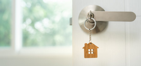 Moving house, relocation. Open the door of the new house, inside the room was a cardboard box containing personal belongings and furniture.の写真素材