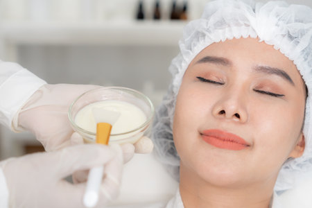 Beautiful woman receive spa and treatment skin of face. face of a healthy woman apply cream. Advertisement for skin cream, anti-wrinkle, baby face, whitening, moisturizerの写真素材