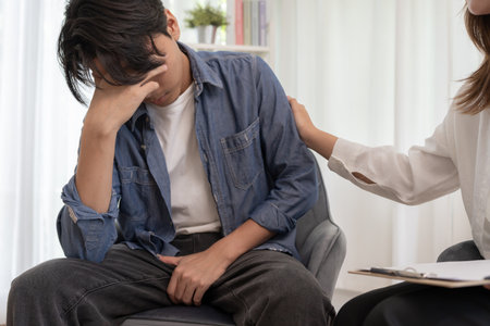 psychiatrist holds shoulders while discussing life and family issues. doctor encourages and empathy man suffers depression. psychological, save divorce,の写真素材