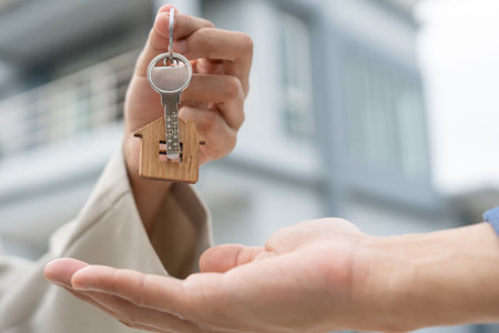 lease, rental and selling home. Real estate agent manager smile holding key for new owner. rent house, Sales, loan credit financial, insurance, Seller, dealer, installment,の写真素材