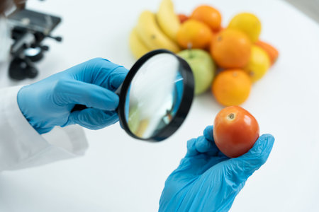 Scientist use magnifying glass to check physical occur from chemical on fruit and vegetable residues...