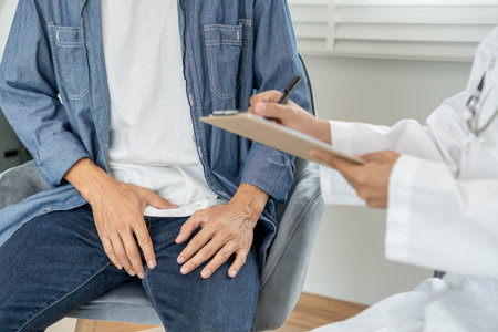 Man hold hand in front of private parts feeling discomfort from disease and inflammation. Venereal, testicular cancer. bladder problems, erectile dysfunction, premature ejaculationの写真素材