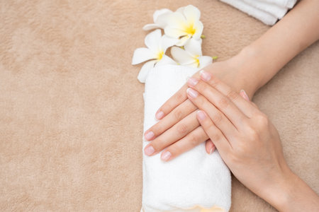 Woman show beautiful nail after receive care service by professional Beautician Manicure at spa centre. Nail beauty salon use nail file for Glazing treatment.の写真素材