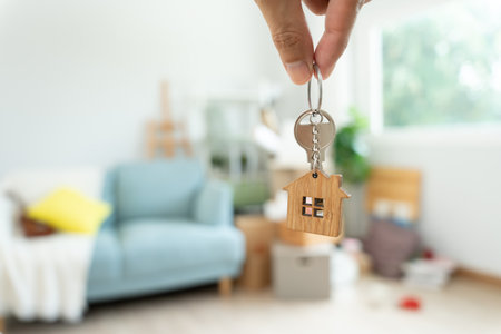 Moving house, relocation. Man hold key house keychain in new apartment. move in new home. Buy or rent real estate. flat tenancy, leasehold property, new landlord, investment,の写真素材