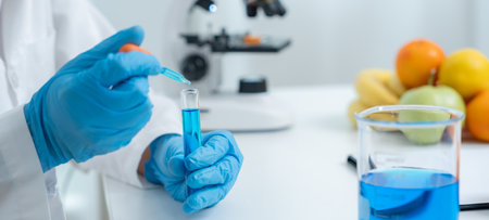 Scientist checking chemical residues in food at a laboratory. Control experts inspect the concentration of chemical residues. Follow ROHs standards, identify prohibited substances.の写真素材