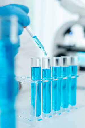 Scientist analyze biochemical samples in advanced scientific laboratory. Medical professional use dropper mix microbiological developmental of viral.の写真素材