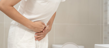 Constipation and diarrhea in bathroom. Hurt woman touch belly  stomach ache painful. colon inflammation problem, toxic food, abdominal pain, abdomen, constipated in toilet,の写真素材